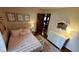 A cozy bedroom with a pink bed, artwork, and matching lamps creates a serene and inviting atmosphere at 1102 Redwood Dr, Brownsburg, IN 46112