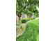 Brick home with mature landscaping featuring large shade tree and green lawn, curb appeal, and charm at 1102 Redwood Dr, Brownsburg, IN 46112