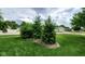 Lush front yard featuring mature evergreens with an eye catching display that enhances the property's curb appeal at 1102 Redwood Dr, Brownsburg, IN 46112