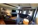 Inviting living room featuring a sectional sofa, an accent chair, hardwood flooring, and a ceiling fan at 1102 Redwood Dr, Brownsburg, IN 46112