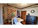 Bright room with custom ceiling trim, vibrant quilts, and a craft table perfect for creative projects at 1102 Redwood Dr, Brownsburg, IN 46112