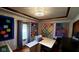 Well lit room featuring custom ceiling, windows, craft table, and vibrant quilts displayed on the walls at 1102 Redwood Dr, Brownsburg, IN 46112