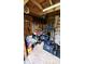 Interior of a shed with a lawnmower and organized tools and Chevrolet Parts sign at 1102 Redwood Dr, Brownsburg, IN 46112