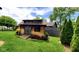 Charming backyard shed with unique architectural details surrounded by lush landscaping at 1102 Redwood Dr, Brownsburg, IN 46112