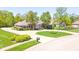 Beautiful brick home with a circular driveway, mature trees, and well-manicured landscaping at 1105 Deer Creek Dr, Anderson, IN 46011
