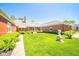 Large backyard with walkway, statue, manicured bushes, and patio set at 1105 Deer Creek Dr, Anderson, IN 46011