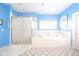 Bathroom featuring a shower and large soaking tub beneath a window at 1105 Deer Creek Dr, Anderson, IN 46011