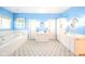 Bright bathroom with a double vanity, soaking tub, white cabinetry and blue walls at 1105 Deer Creek Dr, Anderson, IN 46011