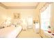 Charming bedroom featuring light yellow walls, floral accents, and a comfortable bed with decorative pillows at 1105 Deer Creek Dr, Anderson, IN 46011