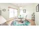 Cozy dining area features a glass table, unique rug, and bright natural light at 1105 Deer Creek Dr, Anderson, IN 46011