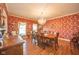 Formal dining room featuring a large table, chandelier, and ornate wallpaper at 1105 Deer Creek Dr, Anderson, IN 46011