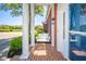 Welcoming front porch with brick flooring, columns, and a cozy bench swing for relaxing at 1105 Deer Creek Dr, Anderson, IN 46011