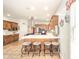 Open concept kitchen with an island and barstool seating plus a stainless steel vent hood at 1105 Deer Creek Dr, Anderson, IN 46011