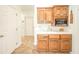 Cozy kitchenette featuring wooden cabinets, white countertops, and access to additional rooms at 1105 Deer Creek Dr, Anderson, IN 46011