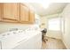 Bright laundry room with washer, dryer, counter space and overhead cabinets at 1105 Deer Creek Dr, Anderson, IN 46011