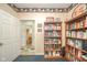 Home office featuring built-in bookshelves and a view of the powder room at 1105 Deer Creek Dr, Anderson, IN 46011