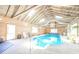 Indoor pool with high vaulted wooden ceiling and ample natural light at 1105 Deer Creek Dr, Anderson, IN 46011