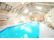 Bright indoor pool area features a wooden ceiling with skylights at 1105 Deer Creek Dr, Anderson, IN 46011