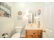 Quaint powder room featuring vanity with wood cabinet and decorative wall art at 1105 Deer Creek Dr, Anderson, IN 46011