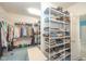 Well-organized walk-in closet with shelving and rods to maximize storage for clothing and accessories at 1105 Deer Creek Dr, Anderson, IN 46011