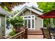 A lovely backyard with a wooden deck, surrounded by lush greenery at 114 E 44Th St, Indianapolis, IN 46205