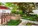 Outdoor space featuring a stone walkway, lush greenery, and a charming wooden deck and table at 114 E 44Th St, Indianapolis, IN 46205