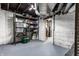 A well-lit basement with painted floors and walls featuring shelving for ample storage space at 114 E 44Th St, Indianapolis, IN 46205