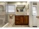 Bright bathroom featuring a glass-enclosed shower, vanity with storage, and neutral tile at 114 E 44Th St, Indianapolis, IN 46205