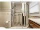 Modern bathroom features a glass shower, tiled walls, and a wooden vanity with great lighting at 114 E 44Th St, Indianapolis, IN 46205