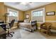 Comfortable bedroom with natural light, complemented by a desk and a wicker chair at 114 E 44Th St, Indianapolis, IN 46205