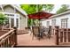 Spacious wooden deck featuring a table, seating, and shade, perfect for outdoor entertaining and relaxing at 114 E 44Th St, Indianapolis, IN 46205