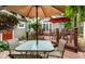 Charming deck area set with a table and chairs beneath a shaded umbrella for outdoor enjoyment at 114 E 44Th St, Indianapolis, IN 46205