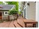 Back deck view featuring stairs and a seating area, overlooking a lush backyard with an outdoor dining table at 114 E 44Th St, Indianapolis, IN 46205