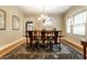 Bright dining room showcasing hardwood floors, a wooden table, and large windows at 114 E 44Th St, Indianapolis, IN 46205