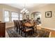 Well-lit dining room featuring a wooden table, chandelier, and a view into the living room at 114 E 44Th St, Indianapolis, IN 46205