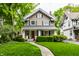 Charming two-story home featuring a well-manicured lawn and inviting front porch at 114 E 44Th St, Indianapolis, IN 46205