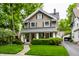 Charming two-story home featuring a well-manicured lawn and inviting front porch at 114 E 44Th St, Indianapolis, IN 46205