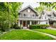 Charming two-story home featuring a well-manicured lawn and inviting front porch at 114 E 44Th St, Indianapolis, IN 46205