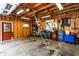 Spacious garage with wooden paneling, an open door, and plenty of storage and workspace area at 114 E 44Th St, Indianapolis, IN 46205