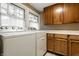 Functional laundry room with modern washer and dryer, plus ample cabinet storage at 114 E 44Th St, Indianapolis, IN 46205
