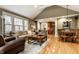 Inviting living room showcasing hardwood floors, comfortable seating, and open layout to kitchen at 114 E 44Th St, Indianapolis, IN 46205