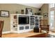 Cozy living room features custom built-ins, shelving, and entertainment center for ample storage at 114 E 44Th St, Indianapolis, IN 46205