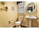 Charming powder room with pedestal sink, oval mirror, and decorative accents and fixtures at 114 E 44Th St, Indianapolis, IN 46205