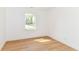 This bedroom features a window letting in natural light and wood-look flooring at 11816 Wapiti Way, Noblesville, IN 46060