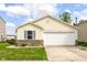 Lovely yellow house with a two-car garage, brick accents, and a neatly kept lawn on a sunny day at 11816 Wapiti Way, Noblesville, IN 46060