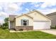 Charming single-story home featuring a two-car garage, brick facade, and well-manicured lawn at 11816 Wapiti Way, Noblesville, IN 46060