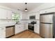 Bright kitchen with stainless steel appliances, white cabinetry, and a window with a view at 11816 Wapiti Way, Noblesville, IN 46060