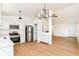 Well-lit kitchen featuring stainless steel appliances, white cabinets, and an open layout to the living area at 11816 Wapiti Way, Noblesville, IN 46060