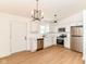 Modern kitchen with stainless steel appliances, white cabinetry, quartz countertops, and new floors at 11816 Wapiti Way, Noblesville, IN 46060