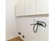 A laundry room with cabinets above connections and light wood flooring at 11816 Wapiti Way, Noblesville, IN 46060